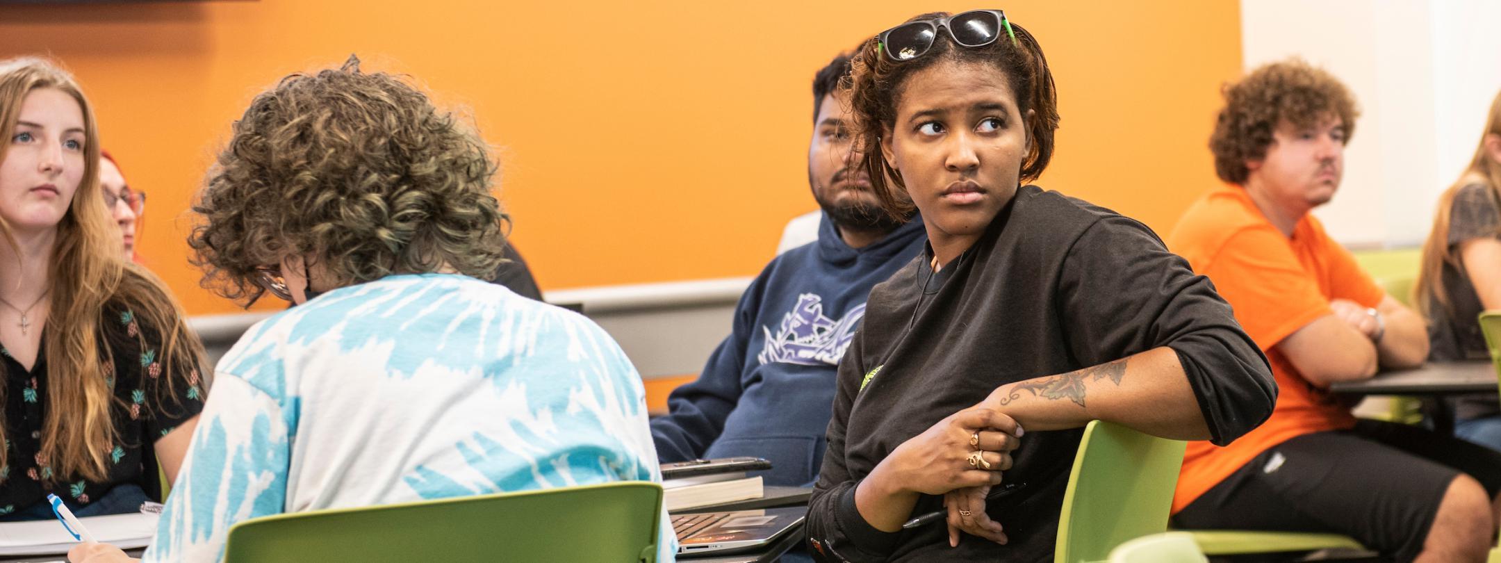 Students listen to a lecture in a COLA classroom.